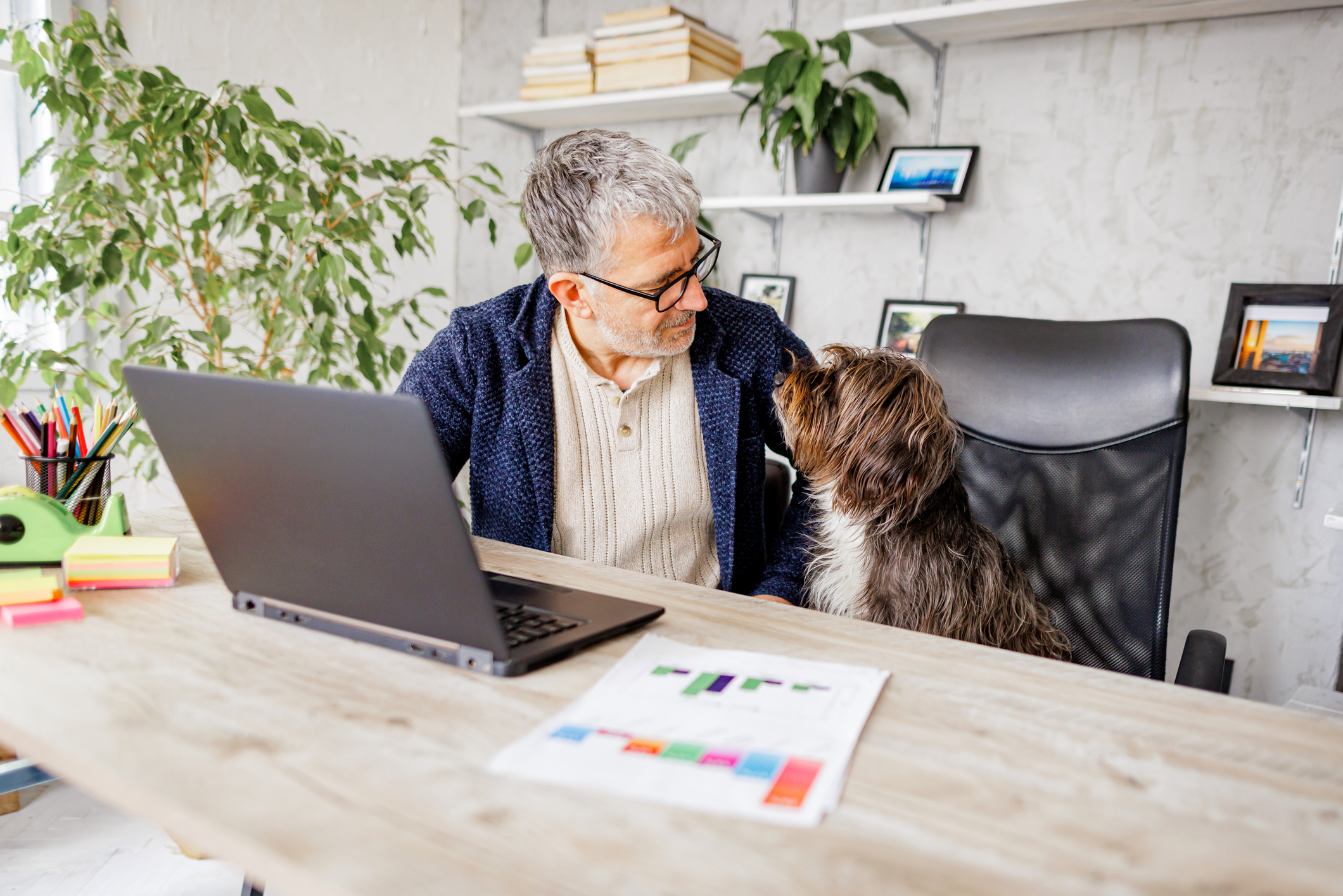 Man and loving dog looking each other in office
